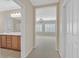 Hallway with views into the bathroom with double vanity sinks and the bedroom with plantation shutters at 2385 Orangeburg Pl, Henderson, NV 89044