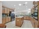 Well-lit kitchen with granite counters, wood cabinets, and stainless steel appliances at 2385 Orangeburg Pl, Henderson, NV 89044