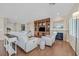 Open-concept living room with hardwood floors, a fireplace, and built-in shelving at 2385 Orangeburg Pl, Henderson, NV 89044
