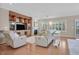 Spacious living room with hardwood floors, a fireplace, and comfortable seating at 2385 Orangeburg Pl, Henderson, NV 89044