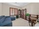 Living Room featuring blue sofa, wooden shelves and shutters at 2385 Orangeburg Pl, Henderson, NV 89044