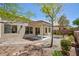 Relaxing backyard with covered patio, desert landscaping, and mature trees offering shade at 2475 Sedona Cedar Ave, Henderson, NV 89052