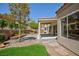 Inviting backyard featuring a covered patio, lush landscaping, and a charming stone walkway at 2475 Sedona Cedar Ave, Henderson, NV 89052