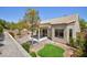 Charming backyard featuring a covered patio, landscaping, and mature trees at 2475 Sedona Cedar Ave, Henderson, NV 89052