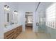 Modern bathroom with double vanity, stylish lighting, and glass-enclosed shower at 2475 Sedona Cedar Ave, Henderson, NV 89052