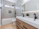 Well-lit bathroom featuring a double sink vanity, modern fixtures, and a shower-tub combo at 2475 Sedona Cedar Ave, Henderson, NV 89052