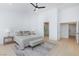Comfortable bedroom with a modern ceiling fan, bench and bedside tables at 2475 Sedona Cedar Ave, Henderson, NV 89052