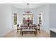 Bright dining area featuring modern light fixture and large windows with natural light at 2475 Sedona Cedar Ave, Henderson, NV 89052