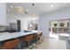 Modern kitchen with sleek countertops, bar seating, and stainless steel appliances at 2475 Sedona Cedar Ave, Henderson, NV 89052
