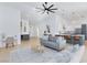 Bright living room features modern furnishings, stylish bar area, and seamless flow to kitchen at 2475 Sedona Cedar Ave, Henderson, NV 89052