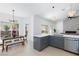 Open-concept living space with modern kitchen, dining area, and comfortable seating at 2475 Sedona Cedar Ave, Henderson, NV 89052