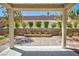 Covered patio with stone pillars, offering a cozy outdoor living space with desert landscaping at 2475 Sedona Cedar Ave, Henderson, NV 89052