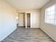 Bright bedroom featuring wood-look floors, a closet with sliding doors, and a window with blinds at 2705 Jennydiane Dr, Las Vegas, NV 89121
