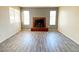Bright living room with a cozy fireplace, wood-look floors, and large windows at 2705 Jennydiane Dr, Las Vegas, NV 89121