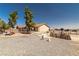 Large backyard with gravel landscaping, mature trees, and a partially fenced perimeter at 2730 Banyon St, Pahrump, NV 89048