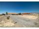 Gravel driveway and front yard leading to a cozy home with a tile roof at 2730 Banyon St, Pahrump, NV 89048
