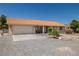 Well-maintained home with a tile roof, attached garage, and landscaped front yard at 2730 Banyon St, Pahrump, NV 89048