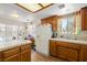 Open concept kitchen with wood cabinets and tile countertops at 2730 Banyon St, Pahrump, NV 89048