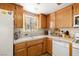 Functional kitchen with tile counters, cabinets and a view from the window at 2730 Banyon St, Pahrump, NV 89048