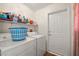 Organized laundry room with washer, dryer, and storage shelves at 2730 Banyon St, Pahrump, NV 89048