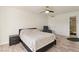 Spacious bedroom with wood-look floors, a ceiling fan, and an ensuite bathroom at 2845 Loveland Dr # 3615, Las Vegas, NV 89109