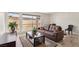 Bright living room featuring a large window, modern floors, and comfortable brown leather sofa at 2845 Loveland Dr # 3615, Las Vegas, NV 89109