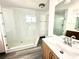 Contemporary bathroom featuring a walk-in shower with glass, wood-look floors and a large mirror at 2903 Hardin Dr, Henderson, NV 89074