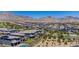 Expansive aerial view of houses with desert mountains in the distance at 312 Wind Poppy St, Las Vegas, NV 89138