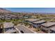Wide aerial view showcasing multiple gray homes in a desert community at 312 Wind Poppy St, Las Vegas, NV 89138