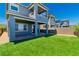 New two-story home with a manicured backyard, covered patio, and turf at 312 Wind Poppy St, Las Vegas, NV 89138
