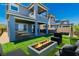 New two-story home with a manicured backyard, fire pit, and covered patio at 312 Wind Poppy St, Las Vegas, NV 89138