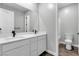 Bright bathroom features double vanity with black faucets, wood look flooring, and toilet at 312 Wind Poppy St, Las Vegas, NV 89138