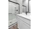 Modern bathroom features glass enclosed shower, sleek white vanity, and quartz countertop at 312 Wind Poppy St, Las Vegas, NV 89138