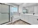 Modern bathroom features double vanity, shower, and a soaking tub with wood look flooring at 312 Wind Poppy St, Las Vegas, NV 89138