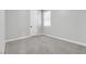 Empty bedroom with gray carpet and a single window at 312 Wind Poppy St, Las Vegas, NV 89138
