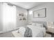 Beautiful bedroom with a bed, shelves, and decorative artwork at 312 Wind Poppy St, Las Vegas, NV 89138