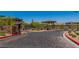Gated community entrance with stone pillars and manicured landscaping at 312 Wind Poppy St, Las Vegas, NV 89138