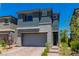 Two-story home with gray stucco, brick accents, and a two-car garage at 312 Wind Poppy St, Las Vegas, NV 89138