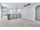 Modern hallway features black metal railing, neutral carpeting, and bright white trim at 312 Wind Poppy St, Las Vegas, NV 89138