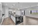 Modern kitchen featuring a large island with granite countertops, stainless steel appliances, and wood flooring at 312 Wind Poppy St, Las Vegas, NV 89138