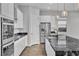 Bright kitchen with white cabinetry, stainless steel appliances, granite countertops and modern pendant lighting at 312 Wind Poppy St, Las Vegas, NV 89138