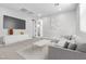 This staged living room features a large sectional, modern console, and a stylish coffee table at 312 Wind Poppy St, Las Vegas, NV 89138