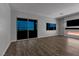 Modern living room at night featuring a fireplace, large windows, and wood floors at 312 Wind Poppy St, Las Vegas, NV 89138