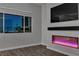 Living room featuring a fireplace and a scenic view from the large window at night at 312 Wind Poppy St, Las Vegas, NV 89138
