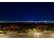 Distant city lights sparkle on the horizon at night at 312 Wind Poppy St, Las Vegas, NV 89138