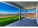 Covered patio overlooking the green turf yard and unobstructed views at 312 Wind Poppy St, Las Vegas, NV 89138