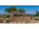 Stone sign for Bristle Vale neighborhood with lush landscaping at 312 Wind Poppy St, Las Vegas, NV 89138