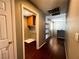 Hallway view featuring the laundry room, shelves, and hardwood floors at 3412 Catherine Mermet Ave, North Las Vegas, NV 89081