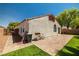 Backyard patio features brick pavers, synthetic grass, and a partial view of the house at 3597 Cherbourg Ave, Las Vegas, NV 89141