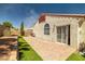Backyard patio features brick pavers, synthetic grass, and access to the house through sliding glass doors at 3597 Cherbourg Ave, Las Vegas, NV 89141